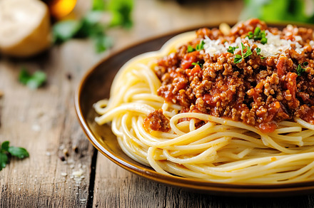 Spaghetti bolognese with ground beef in plate, a Food & Drink Photo by AlyaAnd