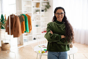 Cheerful Clothing Designer Woman Posing Near Clothing Rail Indoor, a Photo by Prostock-Studio (Thumbnail 1 of 3)