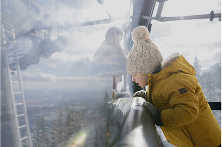 Little boy riding cable car to the, a Holiday Photo by HalfPoint