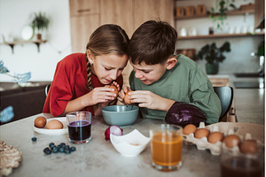 Siblings preparing egshells for, a Holiday Photo by HalfPoint