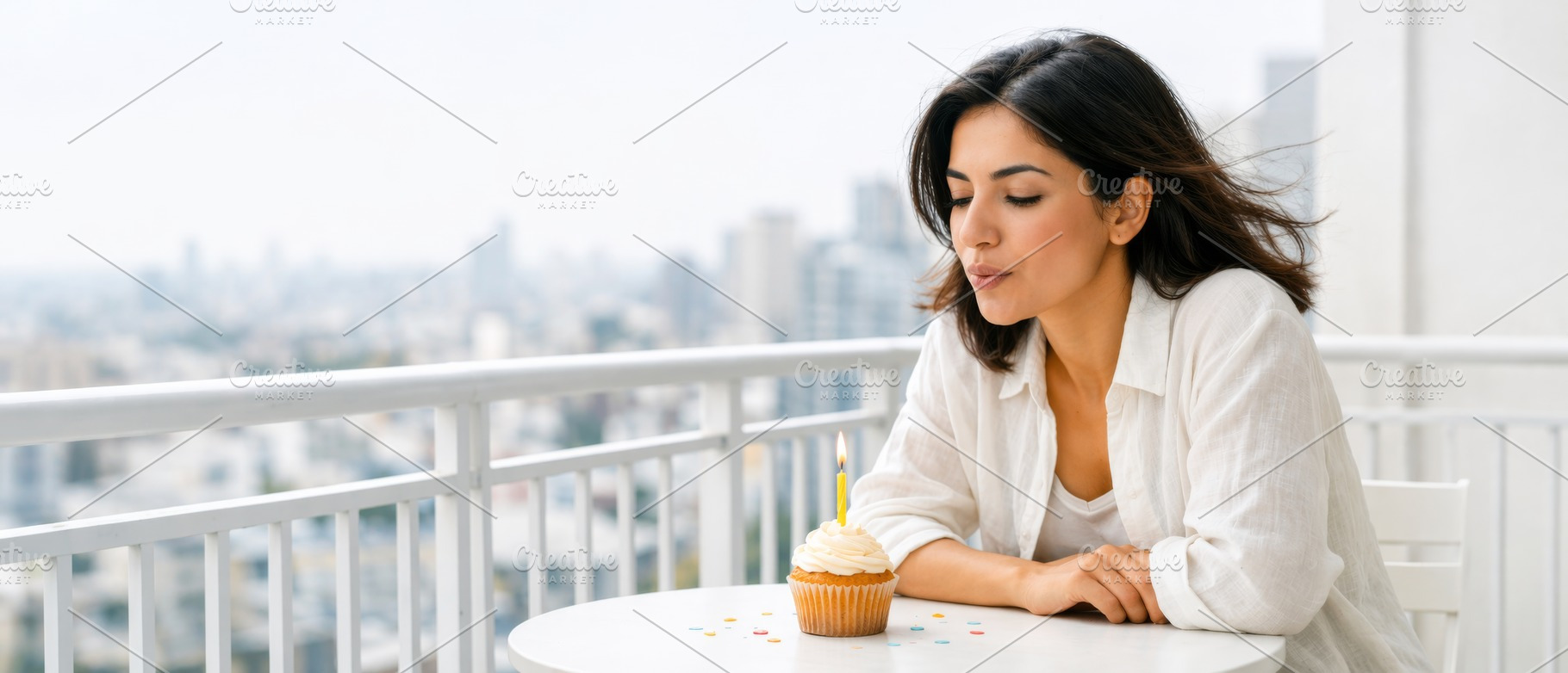Woman blowing out candle on cupcake, a Photo by Dvoevnore photos