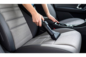Vacuuming a car seat symbolizing, a Transportation Photo by Igor Tichonow