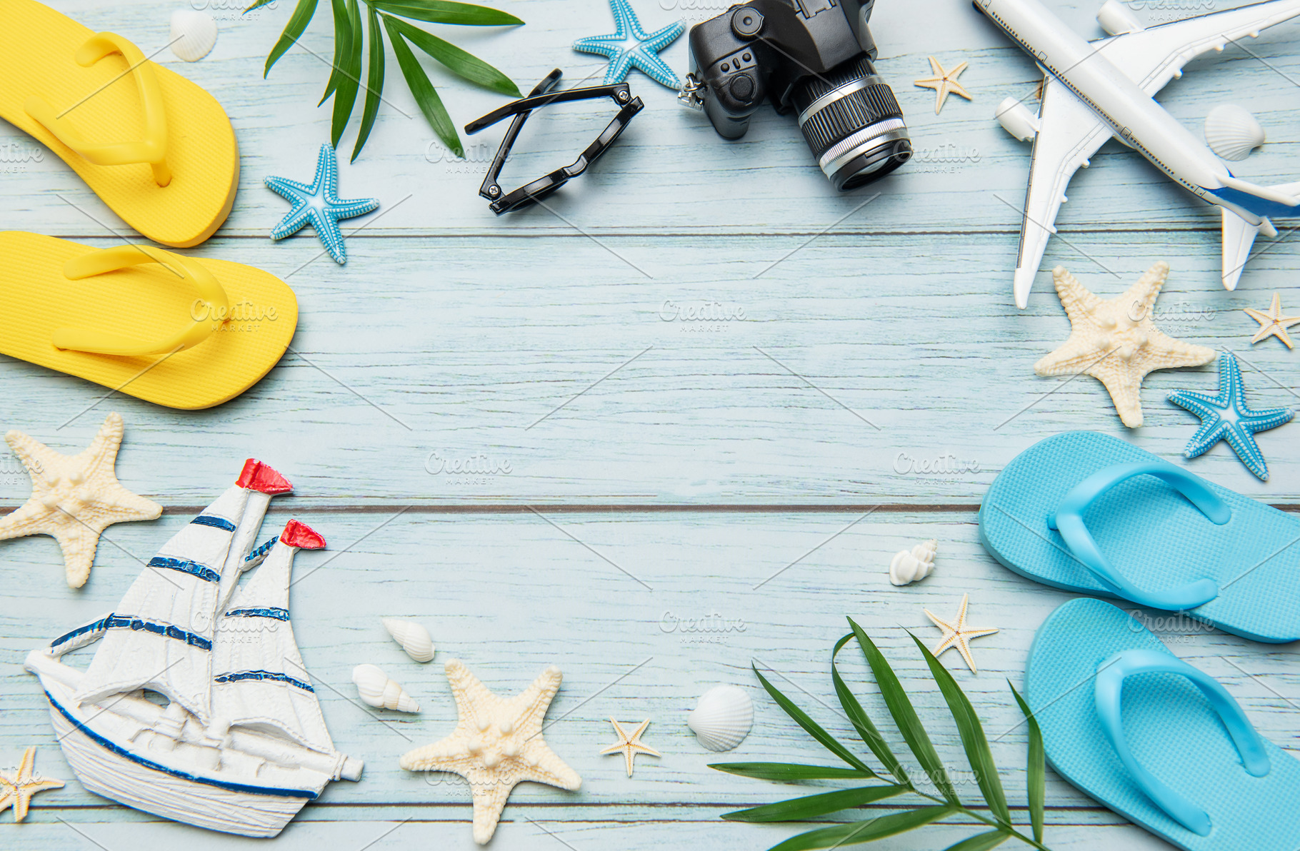 Summer vacation accessories forming a frame on wooden background, a Holiday Photo by Olena Rudo