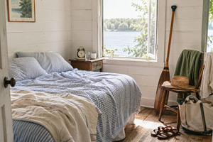 Cozy lakehouse bedroom with rustic d, a Photo by Dvoevnore photos