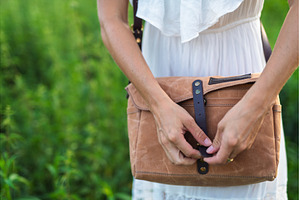 Woman fastening leather strap on, a Person Photo by HalfPoint