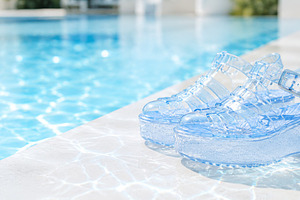 Transparent jelly sandals by a pool,, a Photo by Dvoevnore photos