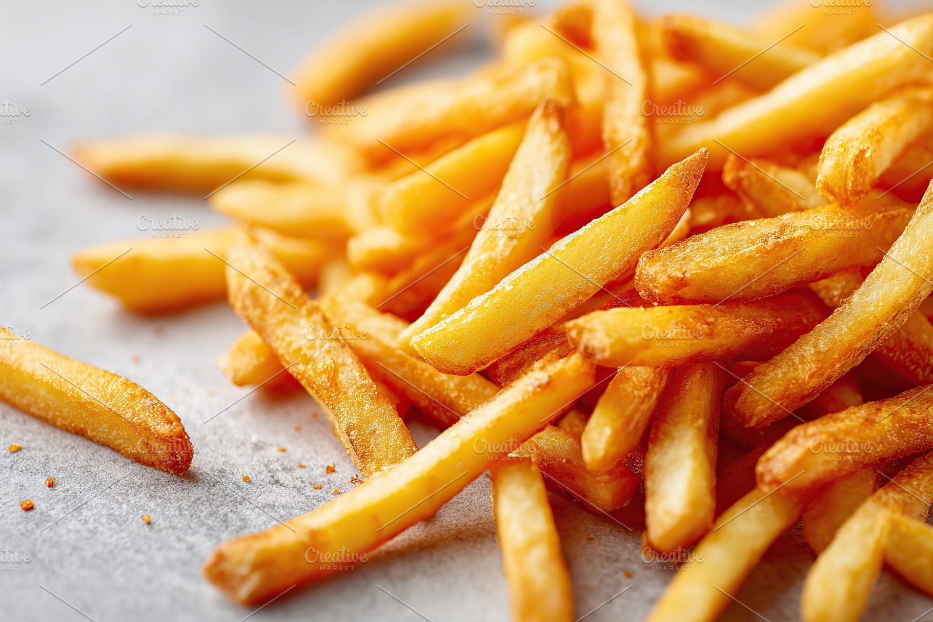 Freshly cooked golden-brown French fries on a light surface ready to be served, a Food & Drink Photo by AlyaAnd
