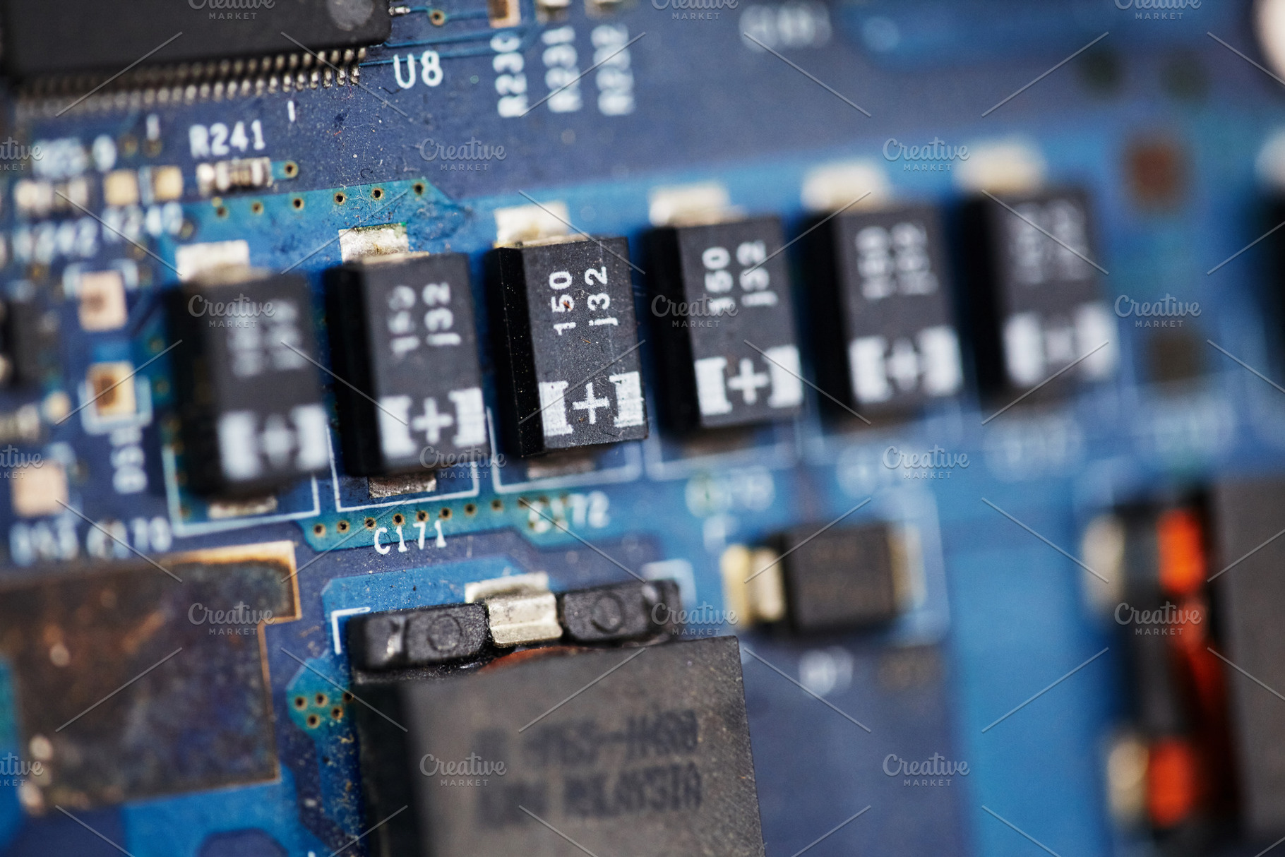 Macro shot of electronic components and microchips on blue PCB., a Technology Photo by Rohan Photography