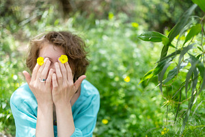 A young woman with curly hair hiding, a Person Photo by Imaginarium