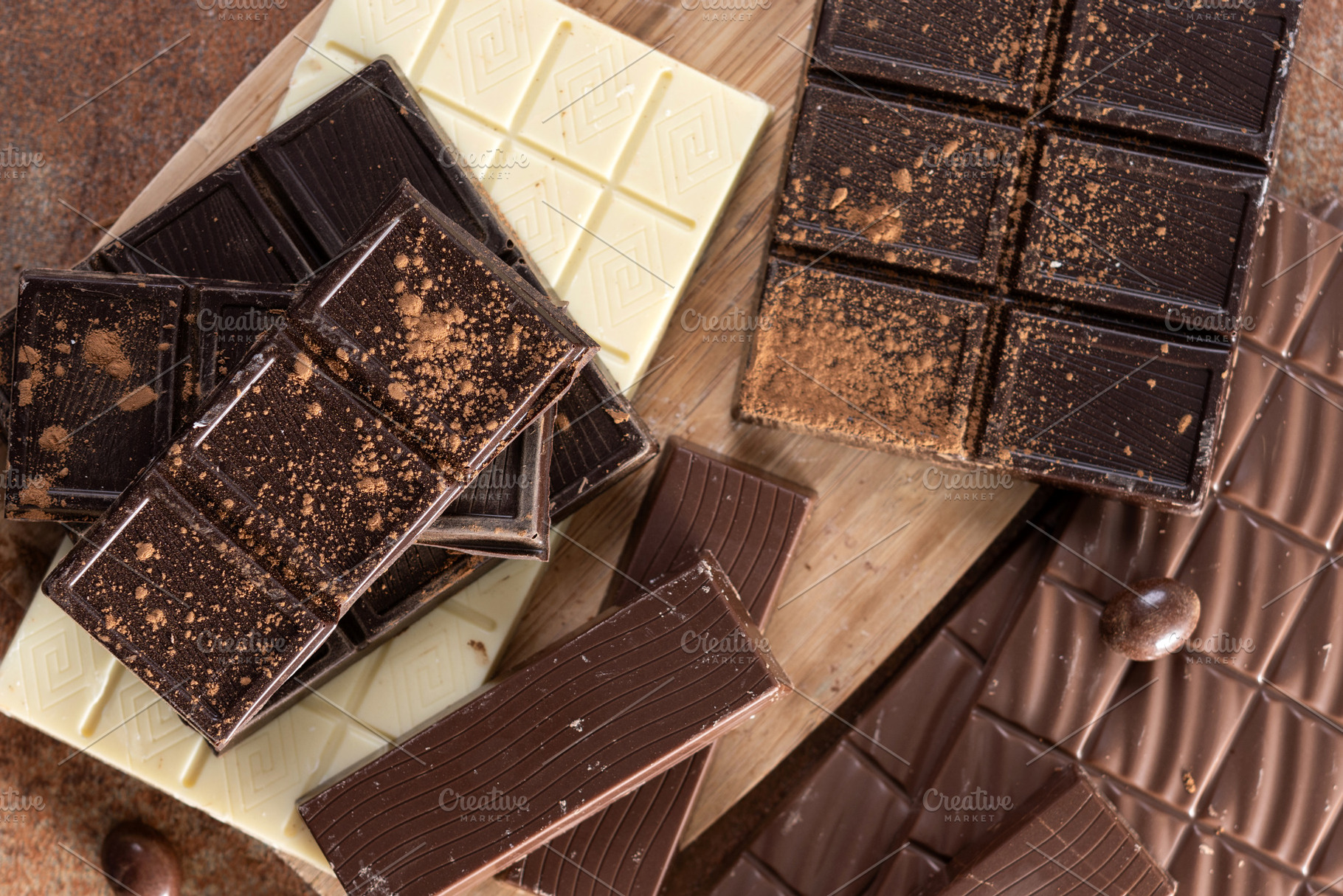Assortment of white, milk and dark chocolate pieces, a Food & Drink Photo by etorres69