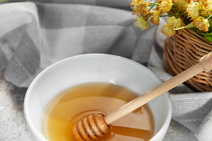Linden honey with dipper and fresh basswood flowers, a Food & Drink Photo by Olena Rudo