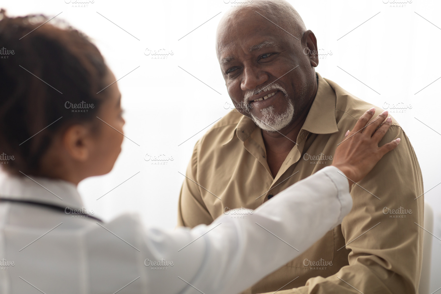 Close up of black female doctor holding male patient's hands, a Photo by Prostock-Studio