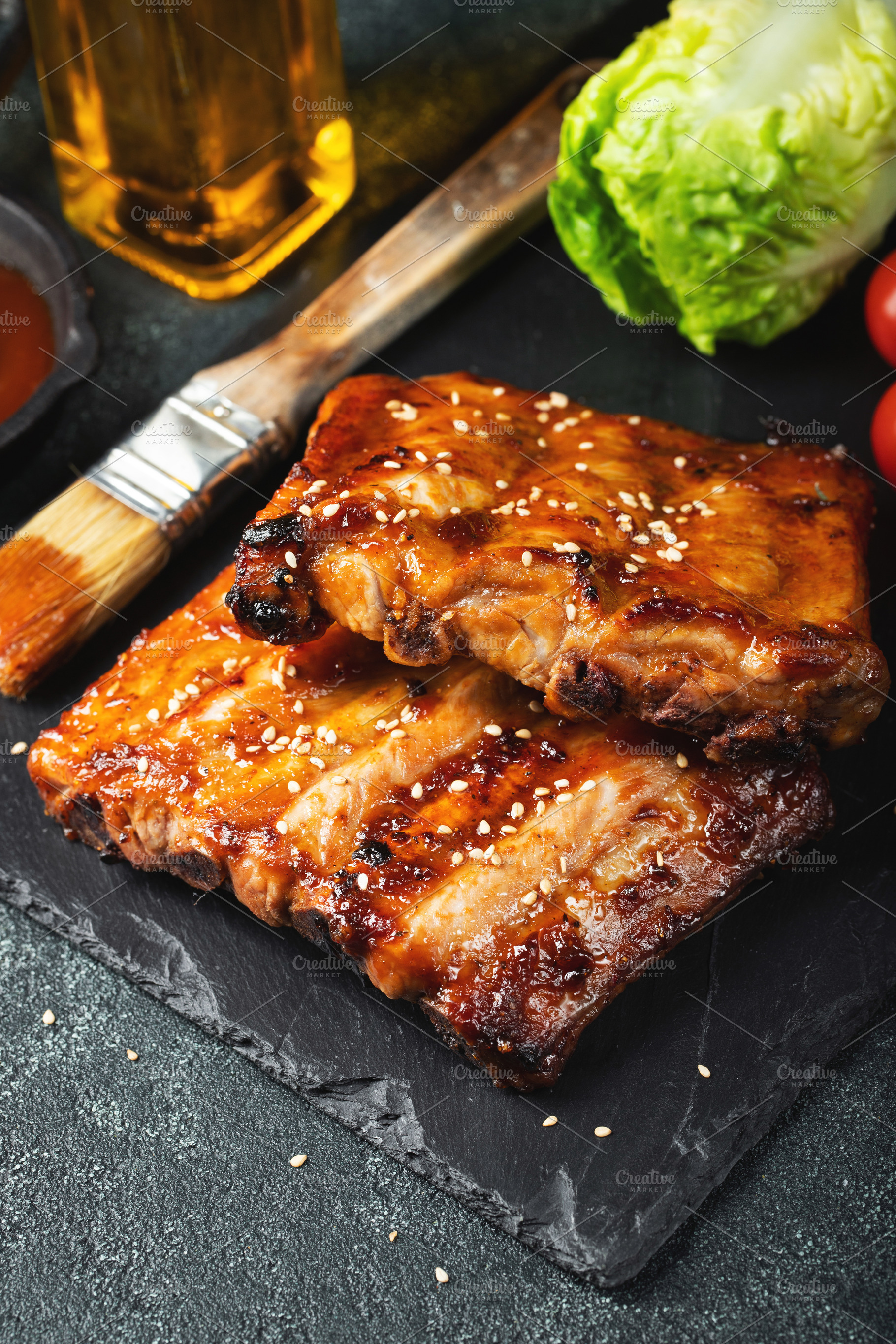 Barbecue pork spare ribs with hot honey chili marinade on black background, a Food & Drink Photo by Budarinphoto