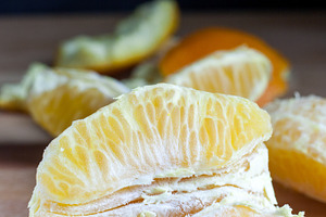 Fresh peeled oranges stock photo containing citrus and cutting board