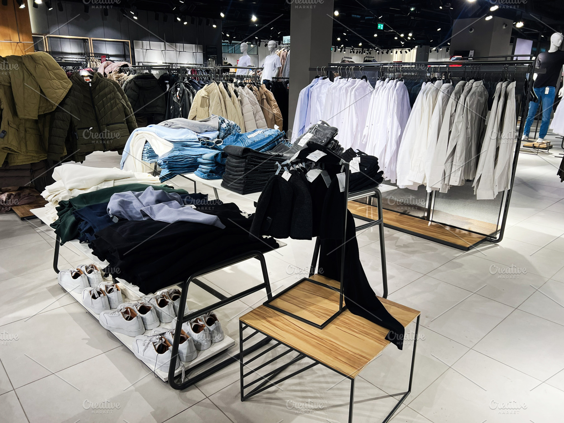Modern retail clothing shop interior with casual and formal apparel displayed, a Photo by AS photostudio