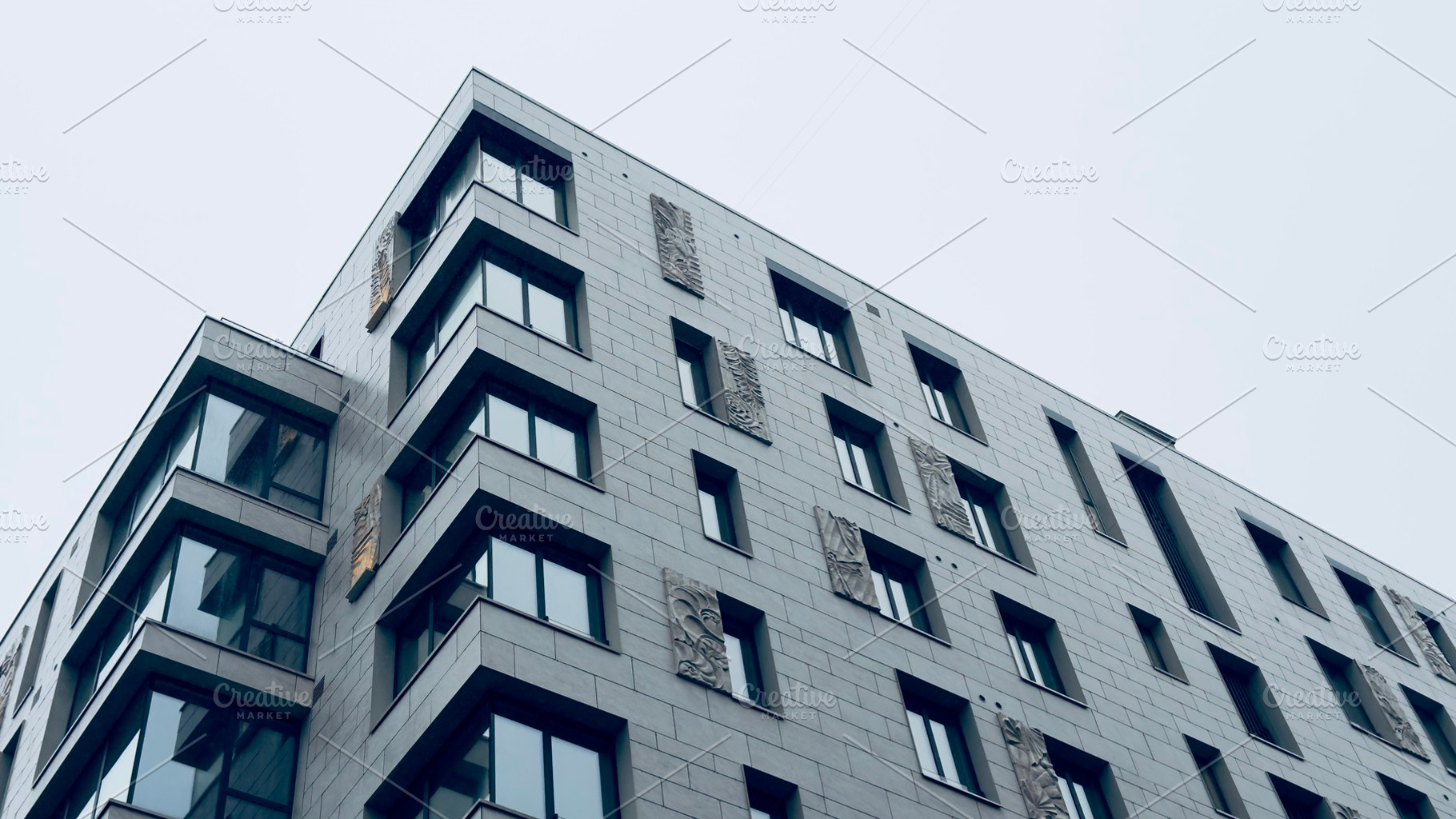 Modern architectural building with large windows and textured facade, an Industrial Photo by Textures & Backgrounds