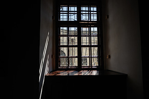 Sunlight streams through a closed wooden window casting intricate shadows indoo, a Photo by AS photostudio