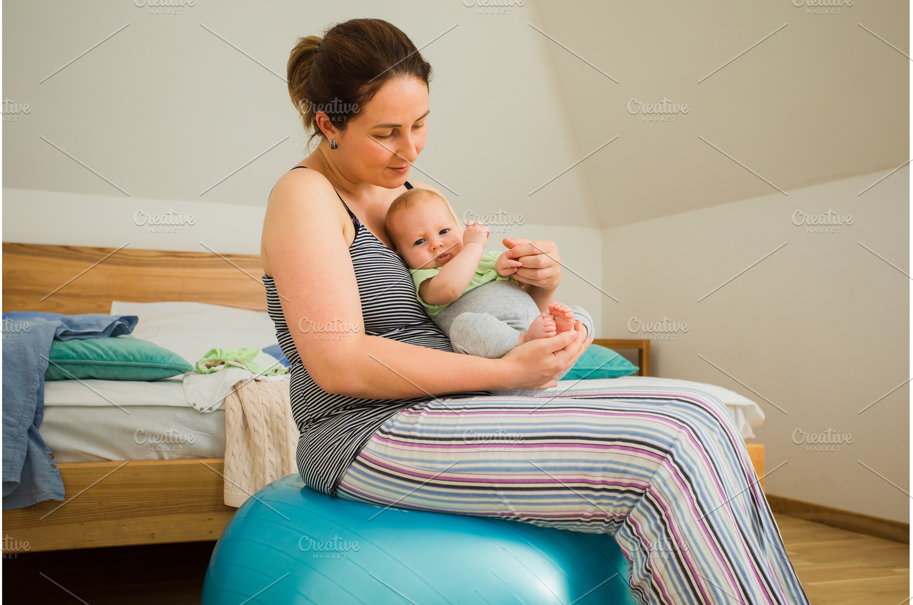 Mother holding and rocking baby, a Person Photo by oksix