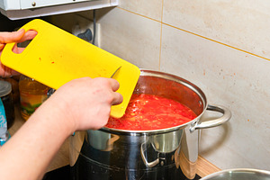 Cooking tomato sauce in big cooking pot, a Food & Drink Photo by Vapi