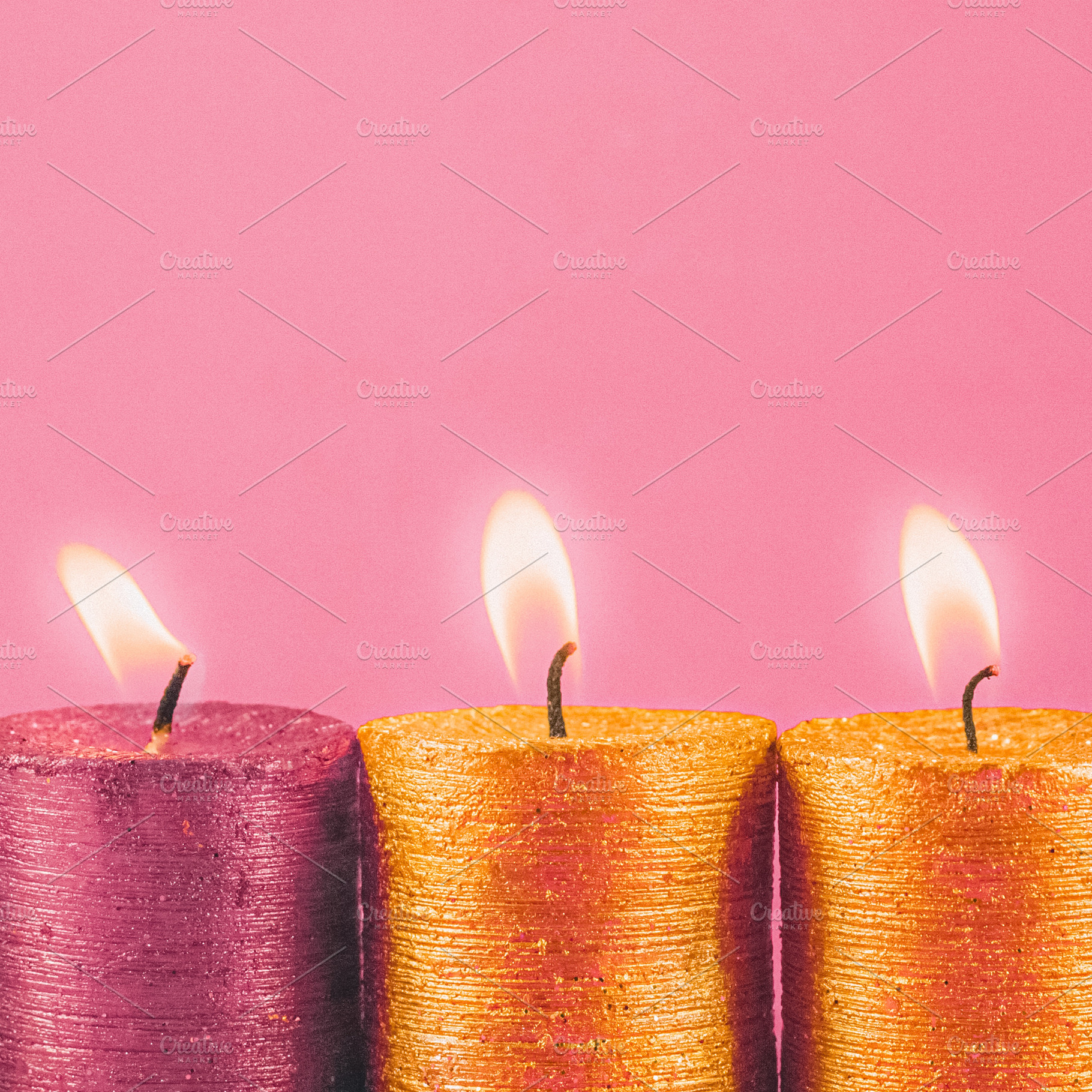 Four shimmering glitter candles casting a cozy light on a gentle, a Photo by Studio ANNA