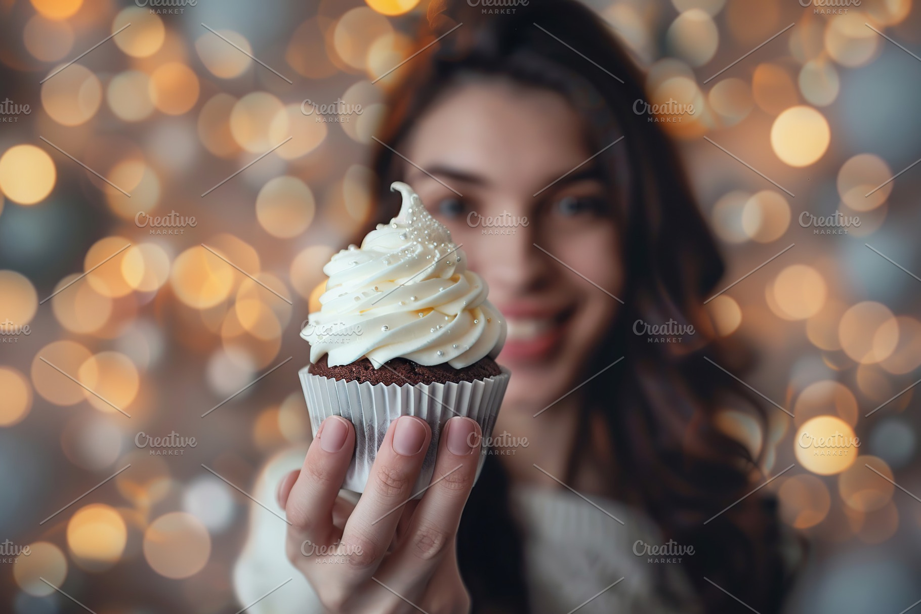 Beautiful woman holding sweet cupcake with whipped cream on blurred lights back, a Person Photo by AlyaAnd