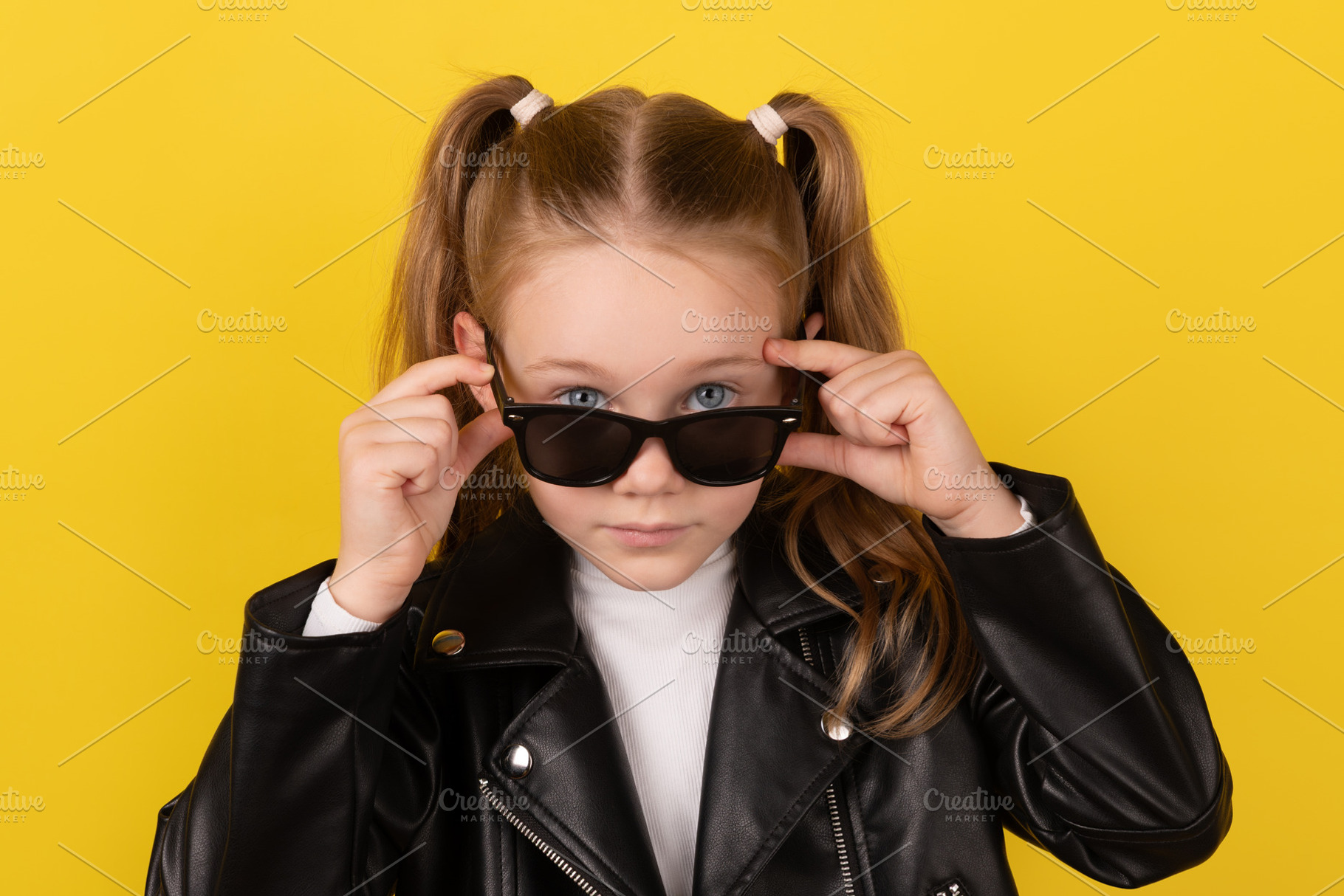 Stylish young girl in a black leather jacket adjusting her sungl, a Person Photo by Ales Munt