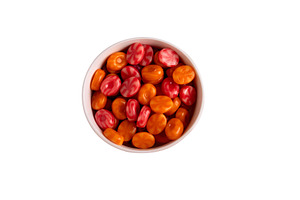 Top view of a white bowl filled with vibrant red and orange hard, a Food & Drink Photo by Ales Munt