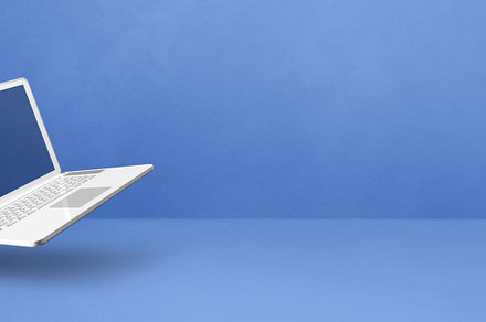 Floating computer laptop isolated on blue. Horizontal banner bac, a Technology Photo by GoodGoods