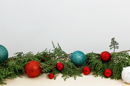 Creating a festive atmosphere, thuja branches and Christmas ornaments on a wood, a Photo by matucha