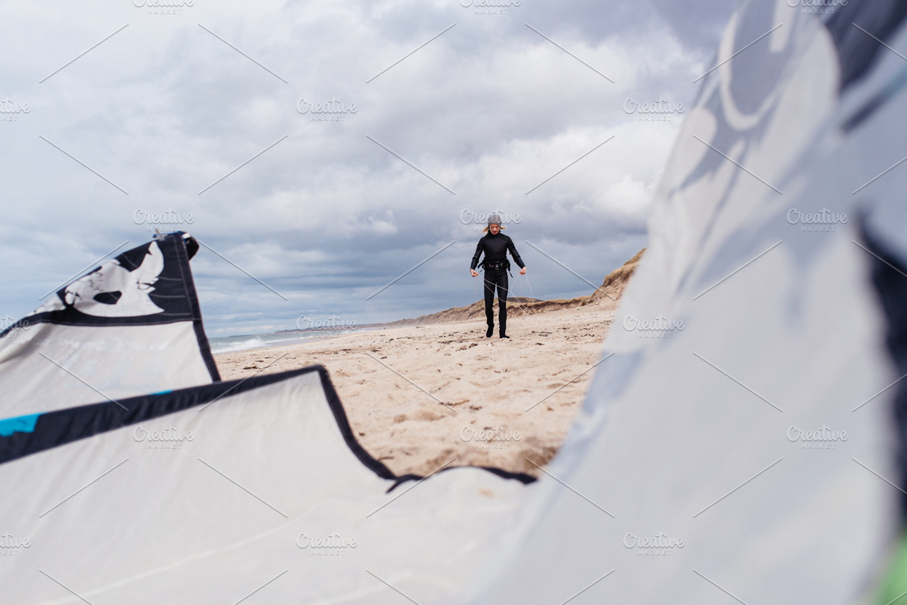 Woman preparing kite for surfing stock photo containing outdoor and sport, a Sports & Recreation Photo by Authentic Outdoor Photos