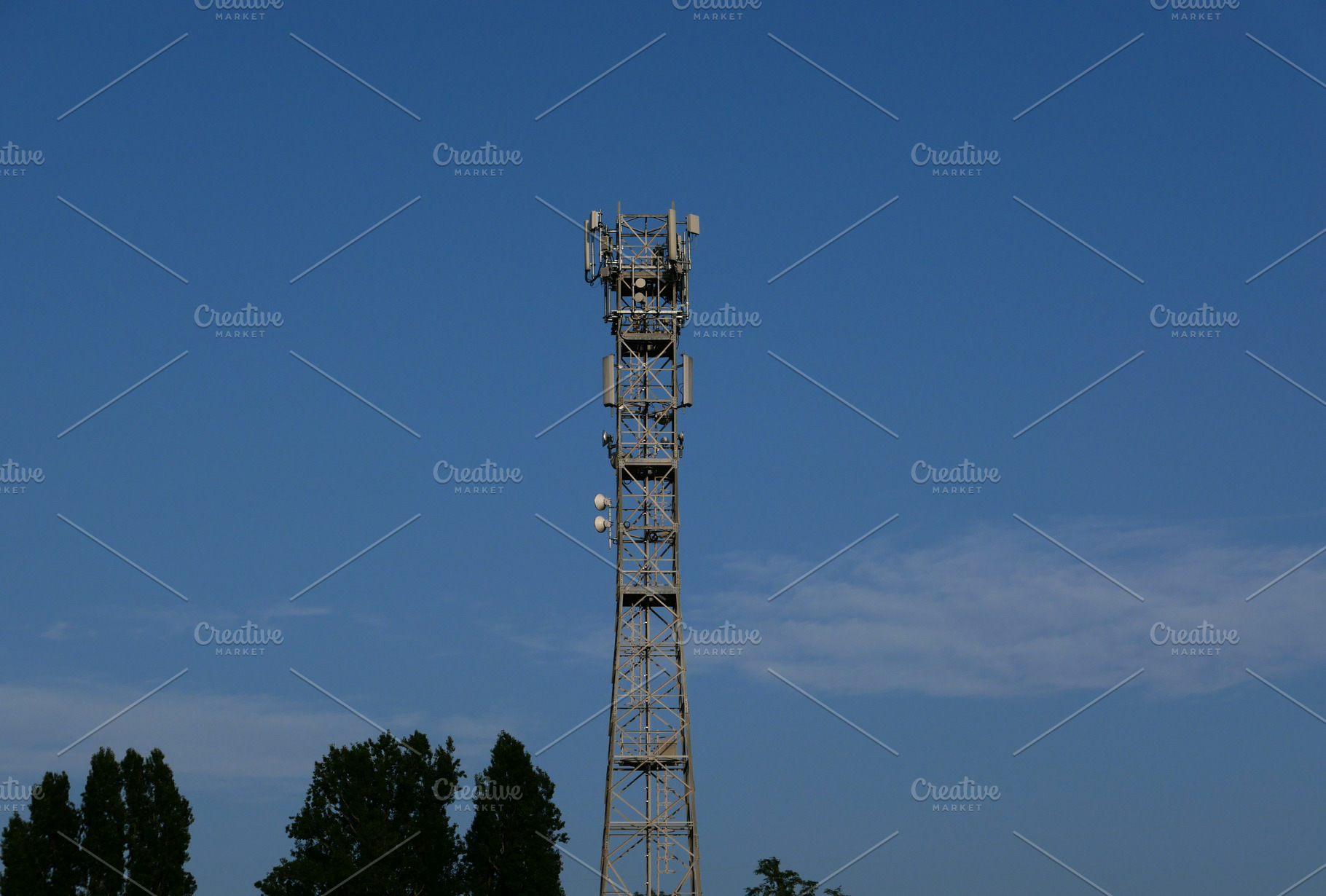 communication tower mast over blue sky, a Photo by WorldOfPhotos