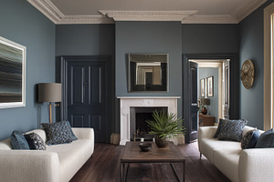 Living room featuring dark blue walls, light sofas, a modern cof, a Photo by Studio ANNA