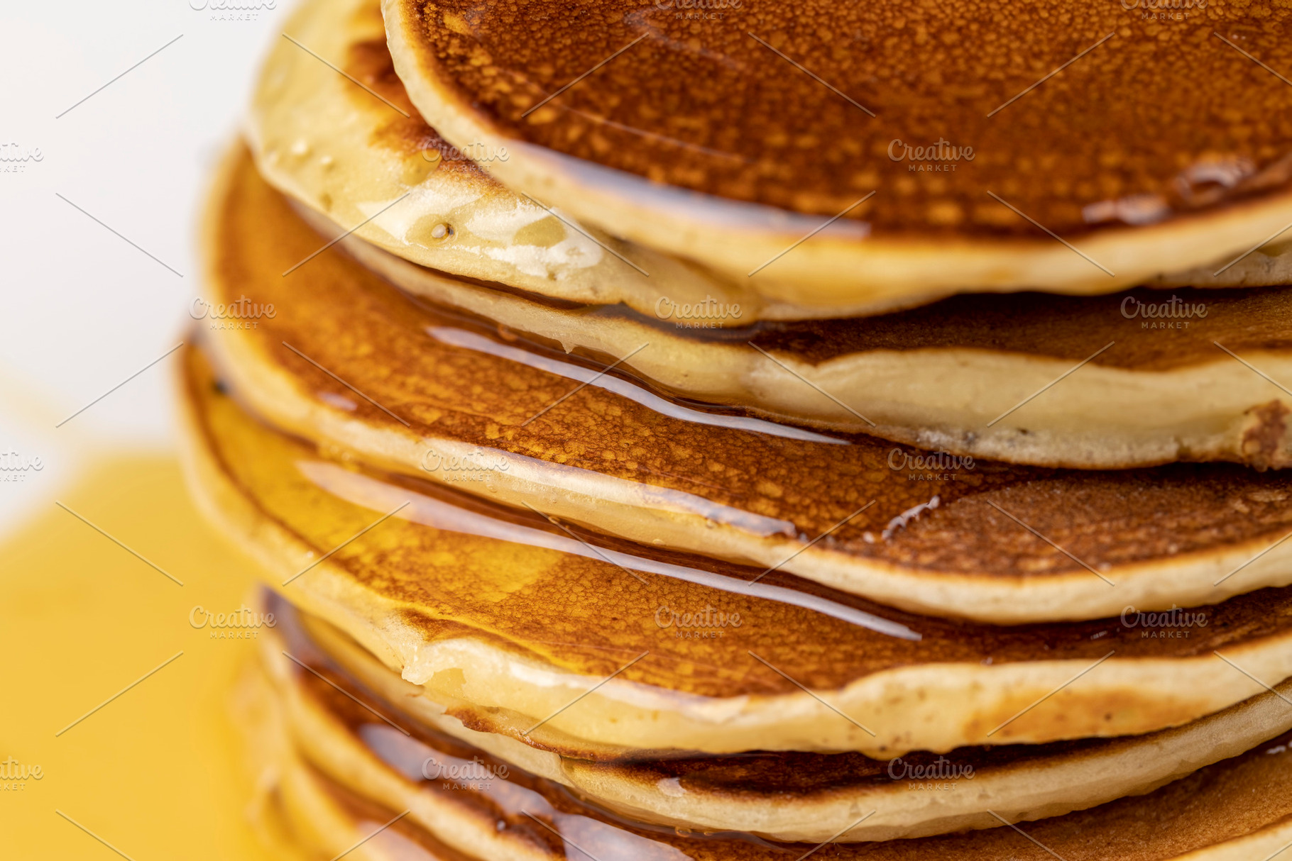 drizzled with honey, a large number of delicious pancakes stacked together on a, a Photo by rsoollAI