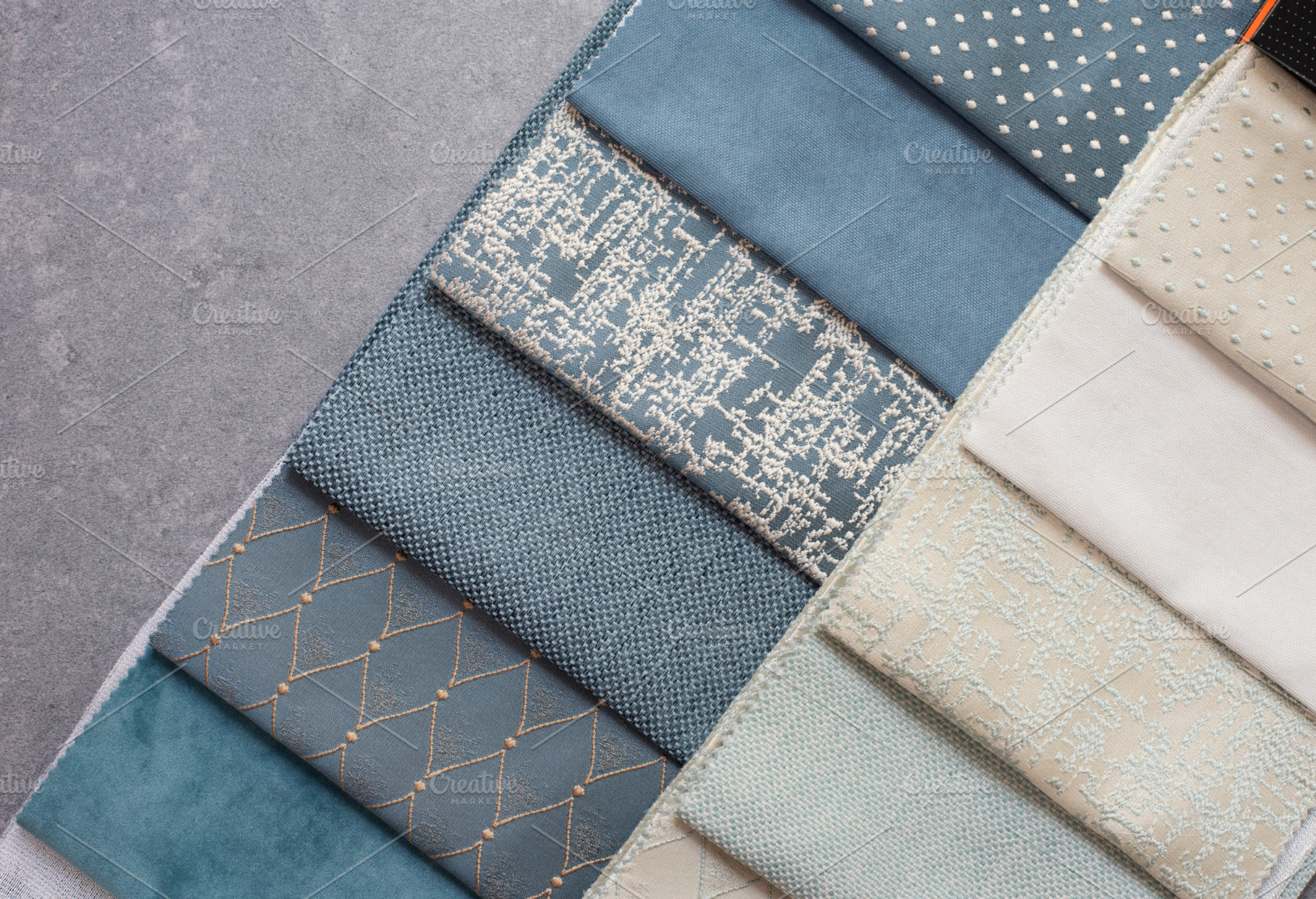 Fabric samples on the table the des containing curtains, blue, and modern, an Industrial Photo by MONNKA