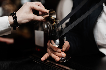 Bartender pours whiskey for tasting.