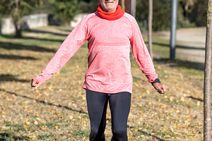 Senior man doing fitness exercises outdoors in autumn park, a Sports & Recreation Photo by RF Images