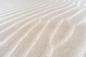 Close-up detail of natural patterns on sand dune surface, a Nature Photo by GoodGoods