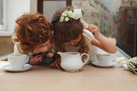 Boy and girl having tea party in featuring tea, party, and kids