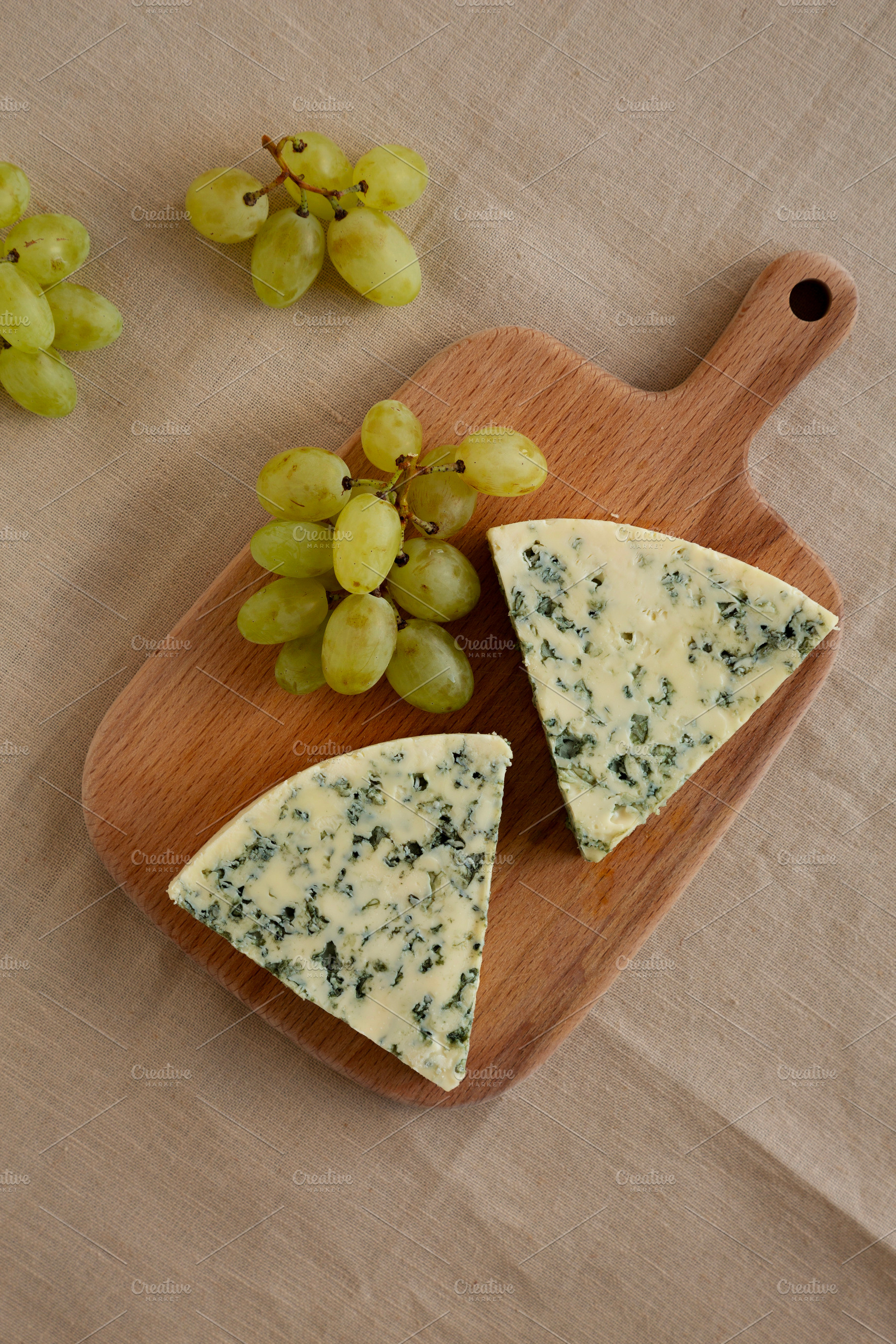 Delicious Cheese Danablu on a wooden board, top view., a Food & Drink Photo by LiudmylaChuhunova