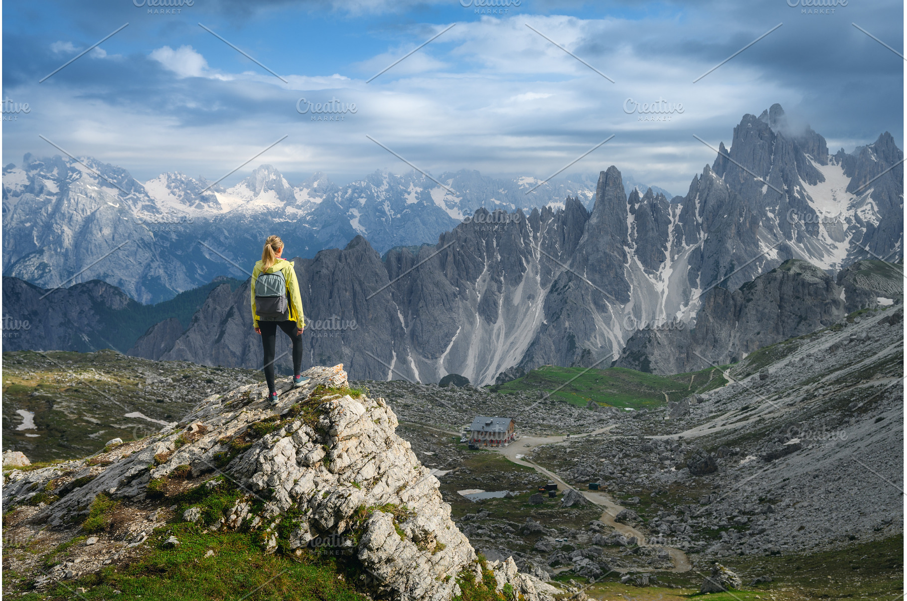 Young woman with backpack on a rock, a Nature Photo by den-belitsky