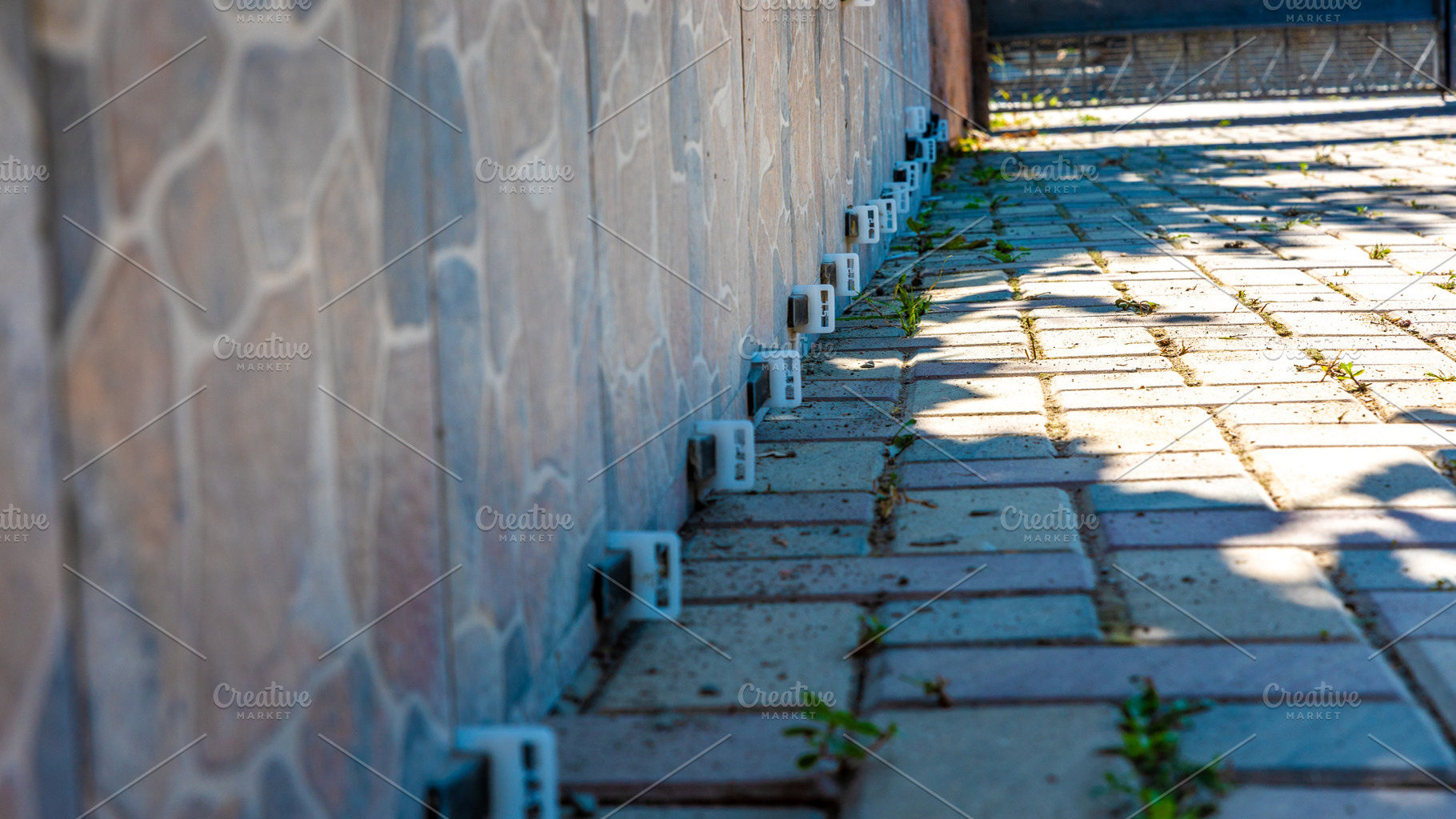 Fence Clips on Brick Pathway, an Architecture Photo by Ales Munt
