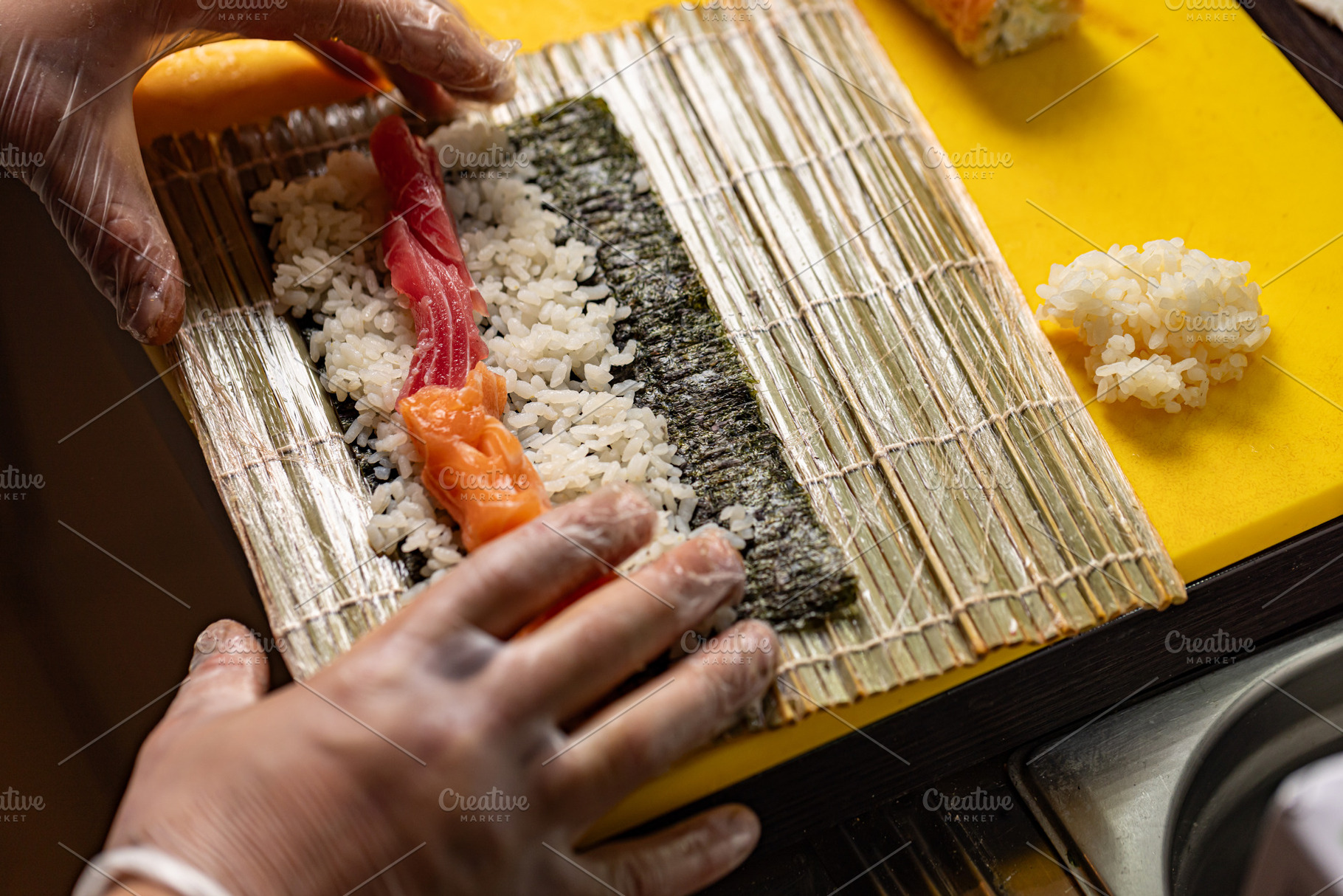 Chef preparing sushi rolls, a Photo by Grafvision photography