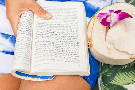 A woman's hands holding a novel