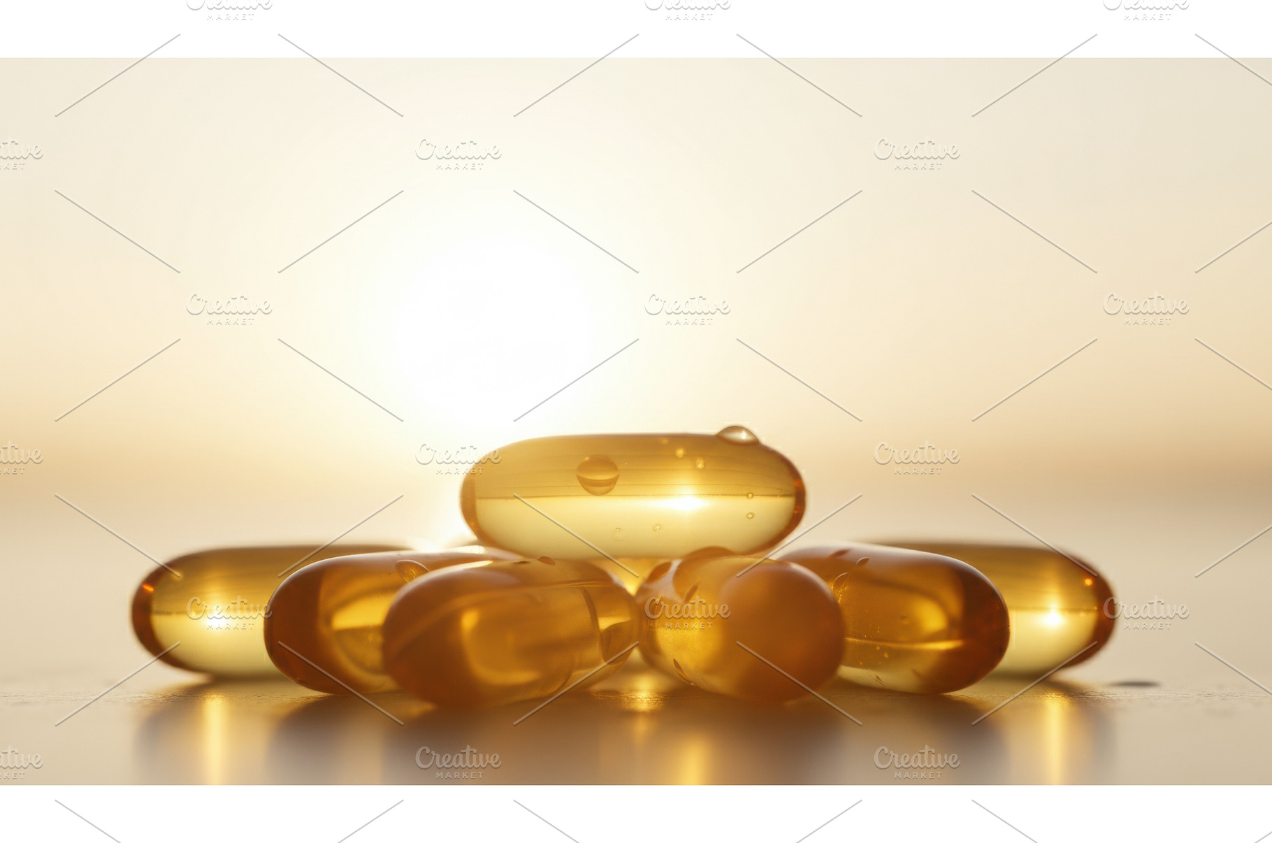 Golden supplement capsules glow in, a Health & Medical Photo by Igor Tichonow