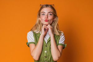 Young woman by orange wall, a Photo by Beautiful things