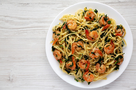 Homemade One-Pot Lemon Garlic Shrimp Pasta on a Plate on a white, a Food & Drink Photo by LiudmylaChuhunova