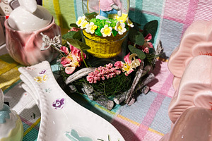 Easter decorations including bunny ornaments and colorful tableware on festive, a Photo by AS photostudio