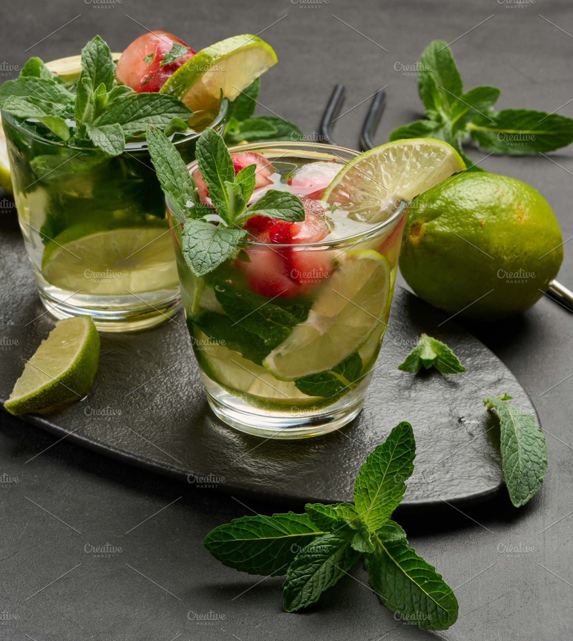 Refreshing mojito cocktail with lime, mint, strawberry, and ice, a Nature Photo by ndanko