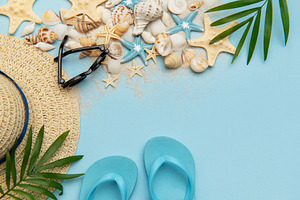 Summer accessories lying on blue background with copy space, a Holiday Photo by Olena Rudo