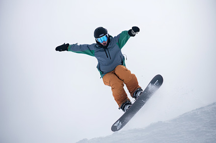 Snowboarder jumping in the air on a, a Photo by Iftikhar Alam